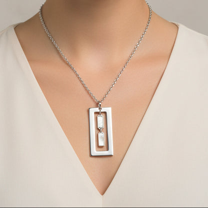 A sterling silver necklace with an open rectangle pendant featuring mother of pearl dangles on an 18.25 inch chain.